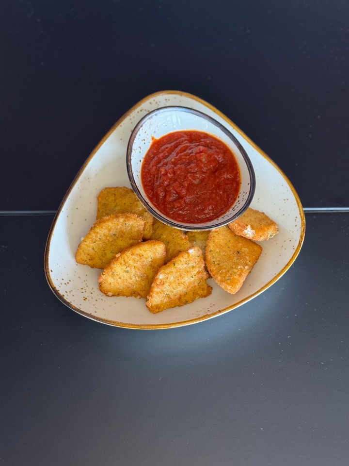Golden fried mozzarella wedges with a side of marinara dipping sauce