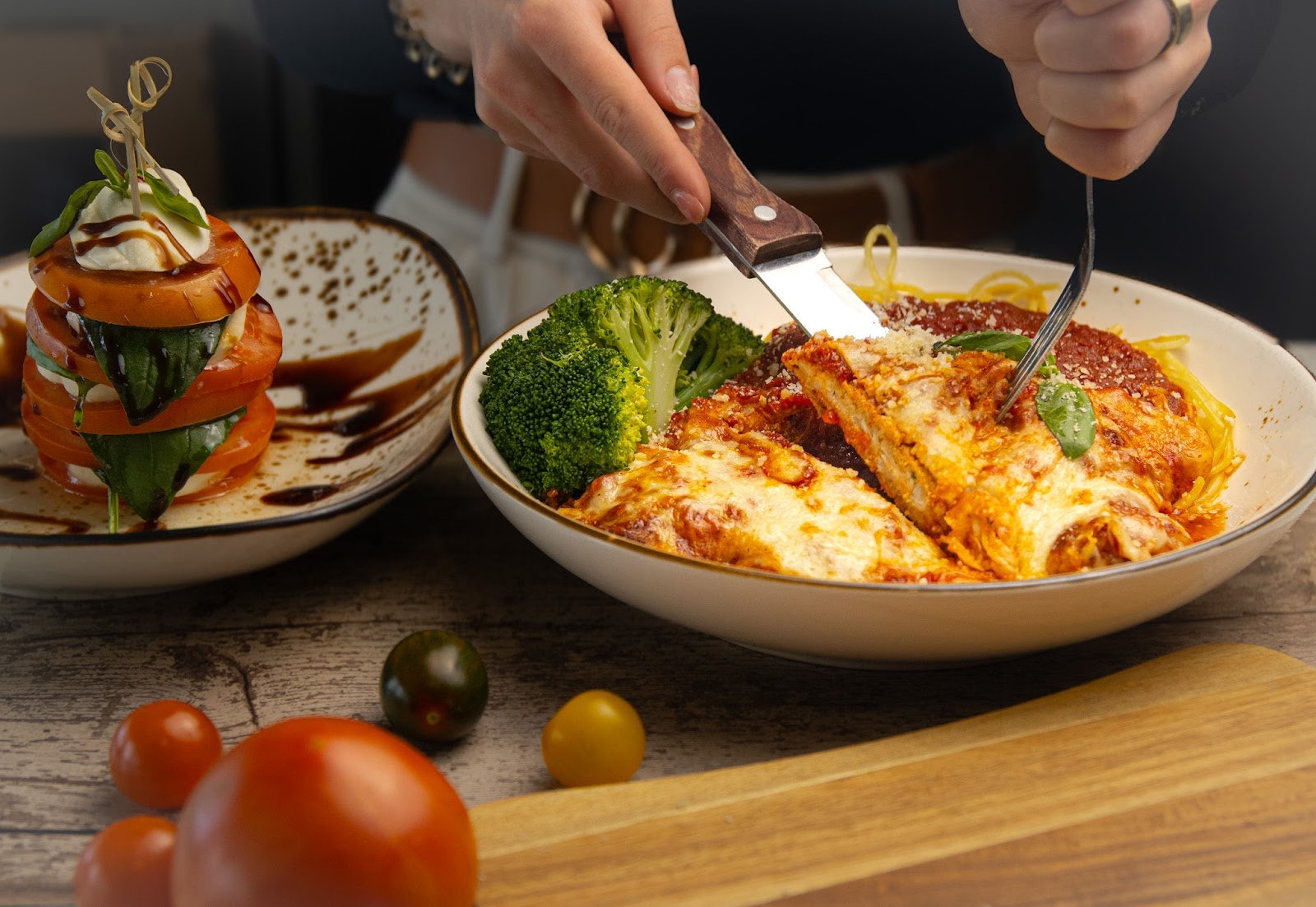 Table-side chicken parmigiana with melted mozzarella, marinara and a caprese tower at Scarpino's Classic Italian in Bradenton