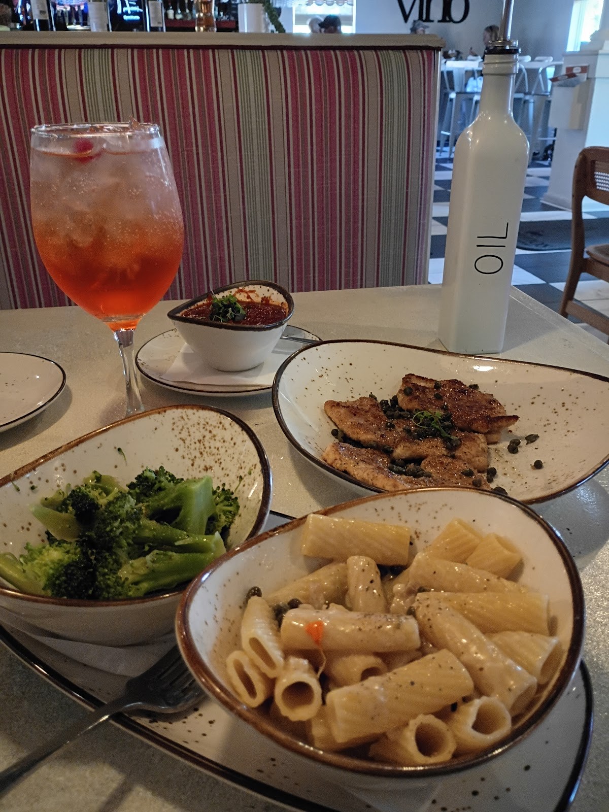 Rigatoni in cream sauce with seared chicken, broccoli and an Aperol spritz